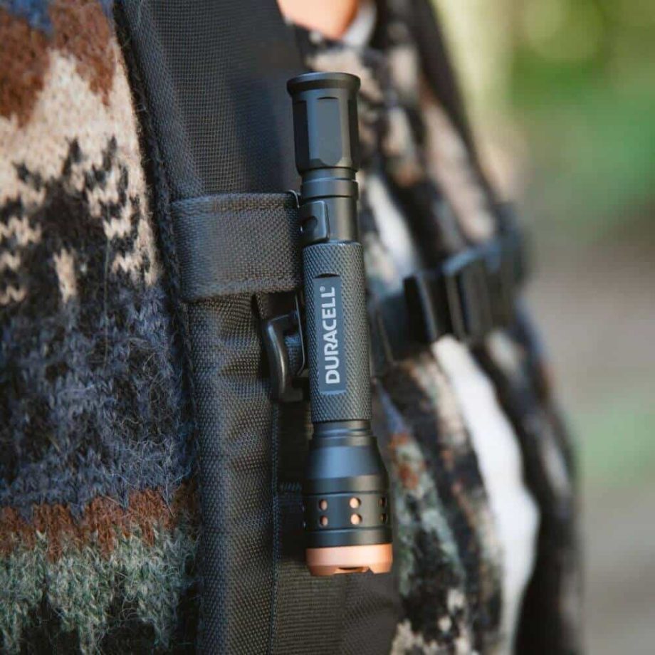 Duracell flashlight clipped into backpack